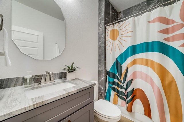 bathroom with vanity, a shower with curtain, and toilet