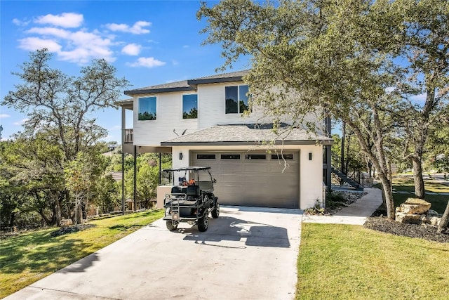 429 Summit Ridge Dr N, Point Venture, TX 78645 - view of front of property featuring driveway, a front lawn, a garage, and a shingled roof