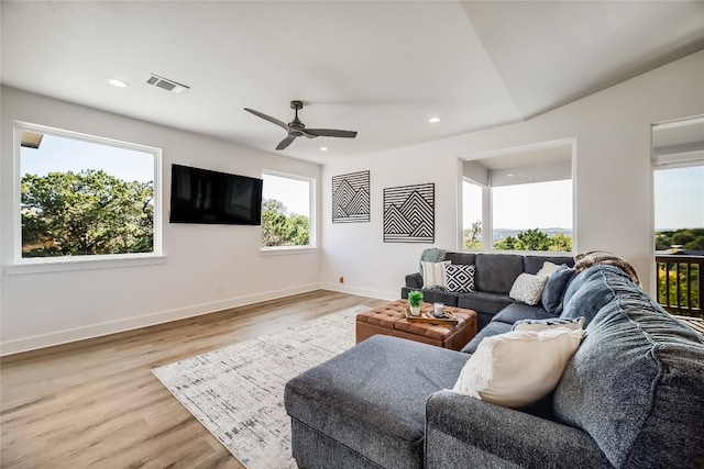 living room featuring light hardwood / wood-style floors and ceiling fan