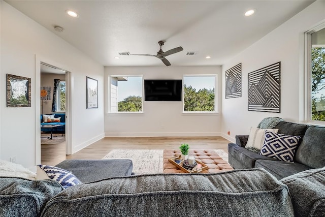 living room featuring a ceiling fan, light wood-style flooring, recessed lighting, and baseboards