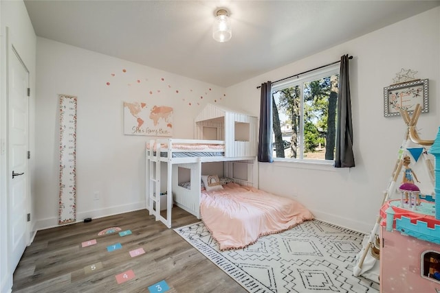 bedroom with dark hardwood / wood-style flooring