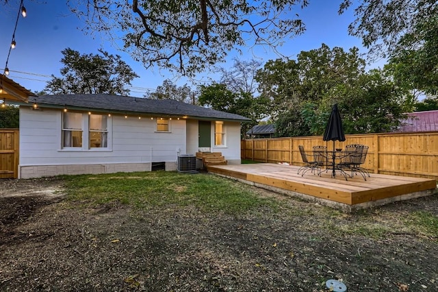 back of property with a wooden deck and central AC unit