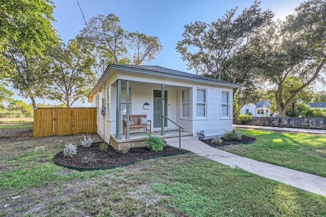 bungalow featuring a porch and a front yard