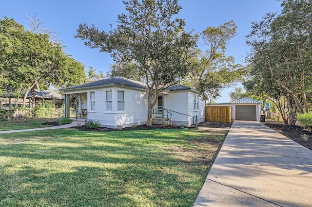 view of front of house with an outbuilding, a garage, and a front lawn