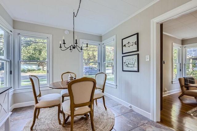 dining area with an inviting chandelier, ornamental molding, dark hardwood / wood-style floors, and a wealth of natural light