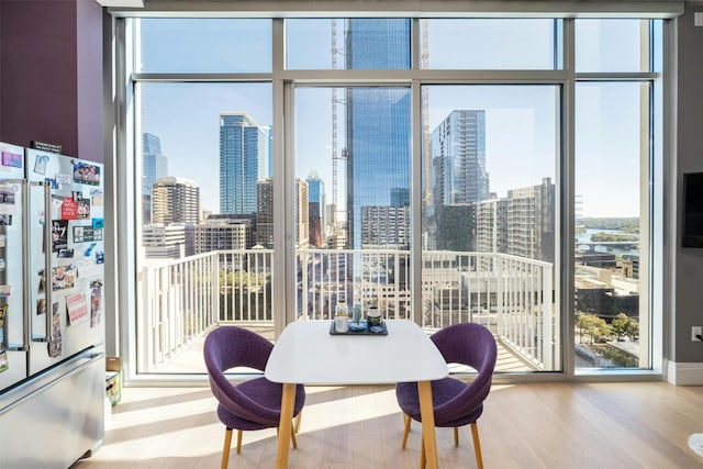 dining area with hardwood / wood-style flooring and floor to ceiling windows