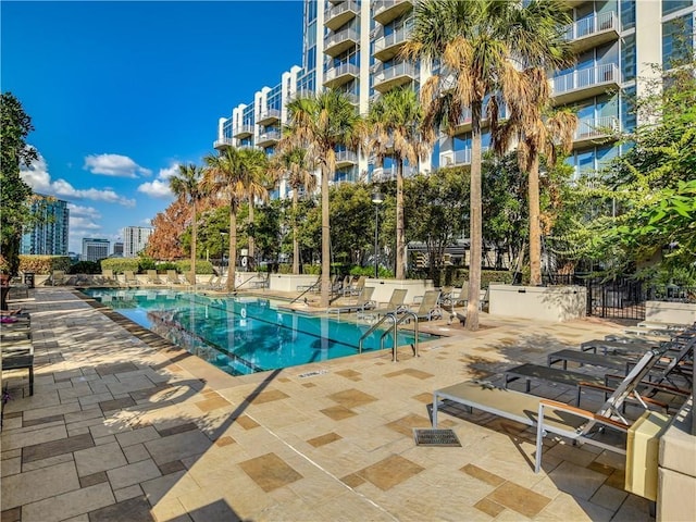 pool featuring a patio area and fence