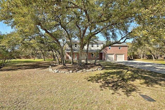 view of front of property with a garage and a front yard