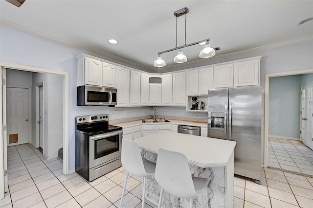 kitchen featuring light tile patterned flooring, a kitchen island, appliances with stainless steel finishes, white cabinetry, and hanging light fixtures