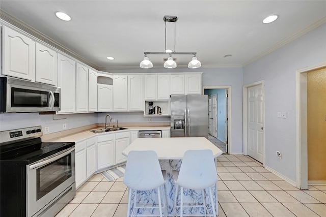 kitchen featuring appliances with stainless steel finishes, sink, hanging light fixtures, a center island, and light tile patterned floors