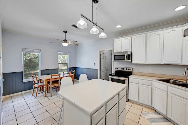 kitchen featuring white cabinetry, pendant lighting, a center island, and appliances with stainless steel finishes