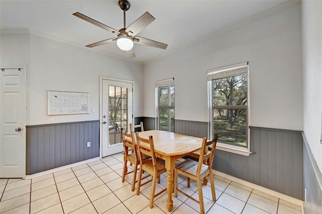 dining area with light tile patterned flooring, ceiling fan, and ornamental molding