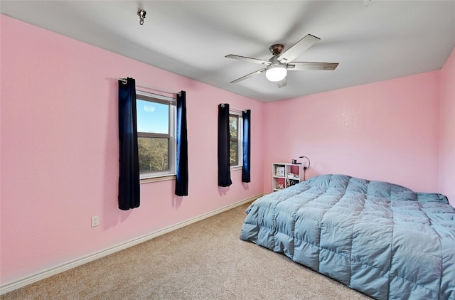 bedroom with ceiling fan and light carpet