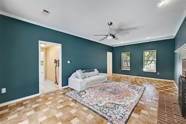 bedroom featuring crown molding, ceiling fan, and a fireplace