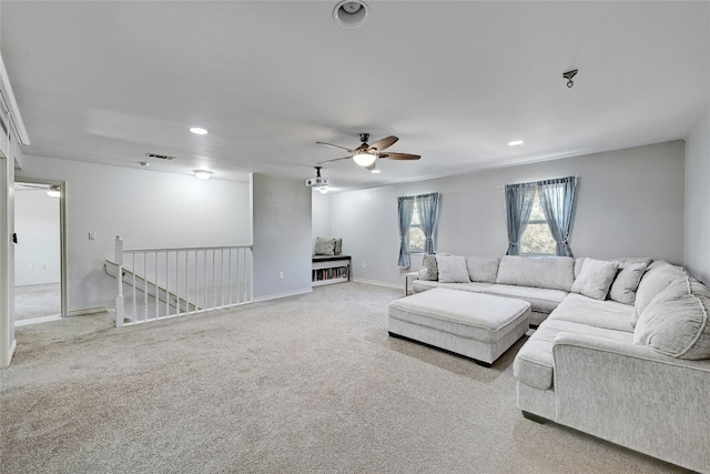 carpeted living room with ceiling fan