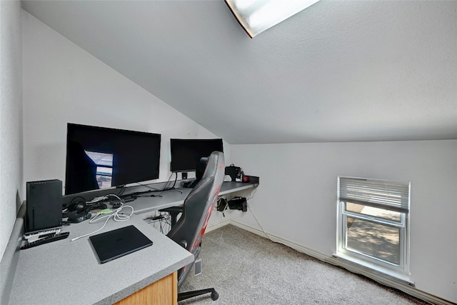 home office featuring lofted ceiling and light carpet