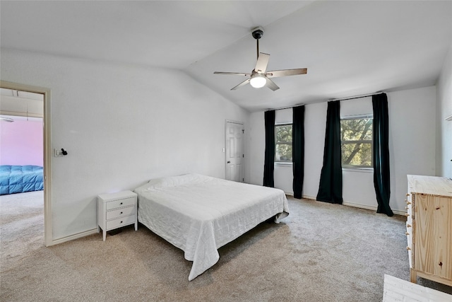 carpeted bedroom with lofted ceiling and ceiling fan