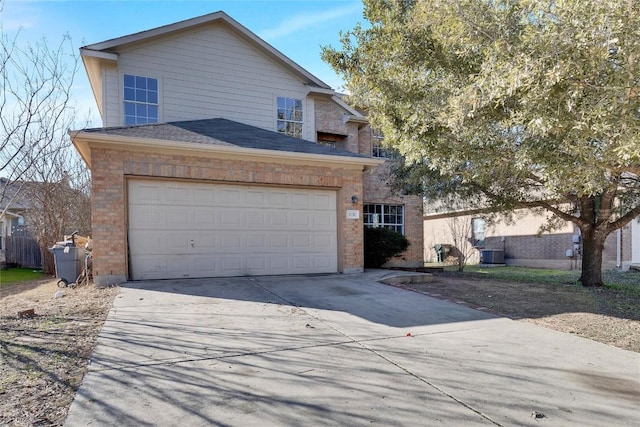 view of front of house featuring a garage and central AC unit