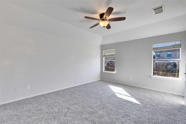 carpeted empty room featuring a healthy amount of sunlight and ceiling fan