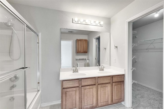 bathroom with vanity and shower / bath combination with glass door