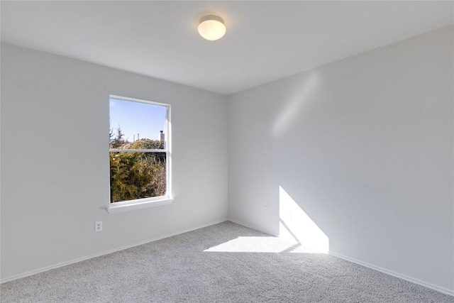 unfurnished room featuring light colored carpet