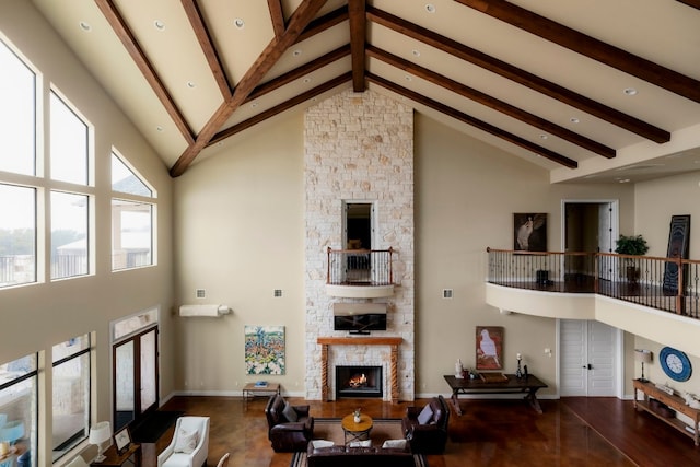 living room featuring beam ceiling, a fireplace, high vaulted ceiling, and wood-type flooring