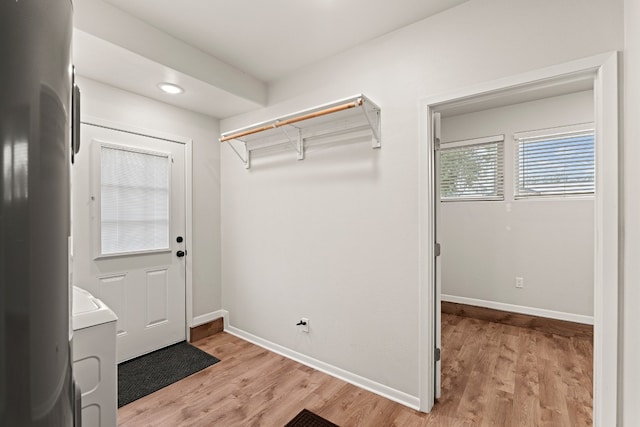 washroom with washer / dryer and light hardwood / wood-style floors