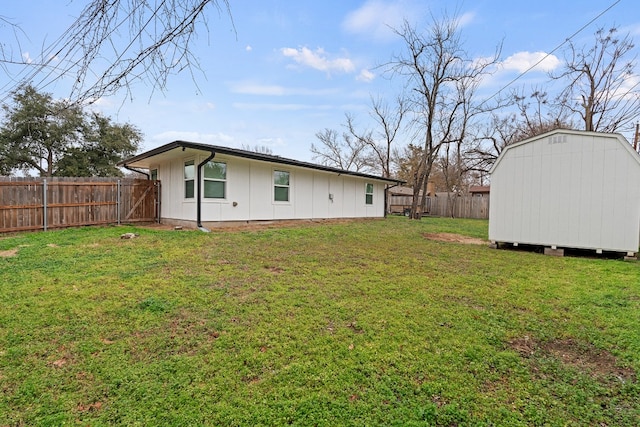 back of house with a yard and a storage unit