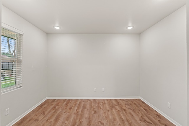 spare room featuring a wealth of natural light and light wood-type flooring