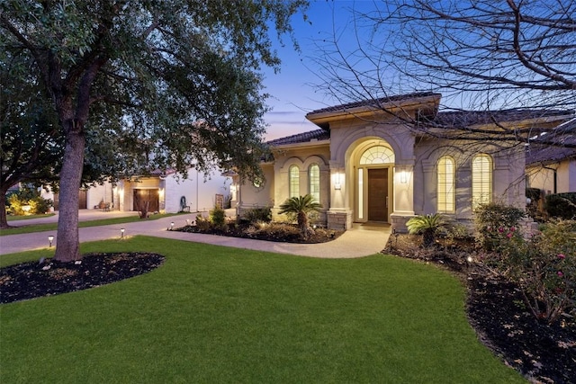 mediterranean / spanish-style house featuring a lawn