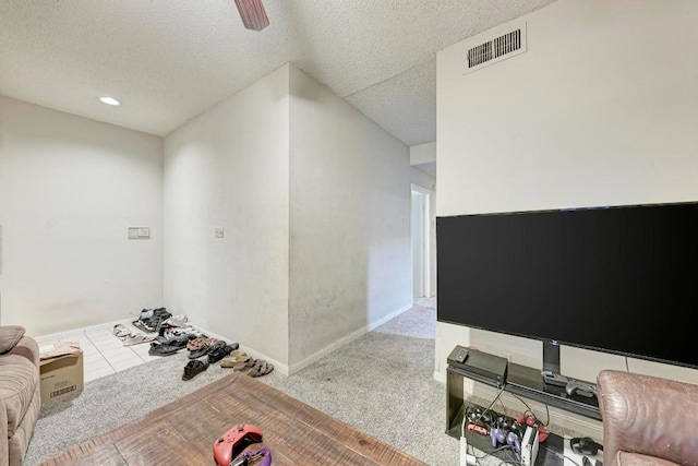 interior space featuring ceiling fan and a textured ceiling