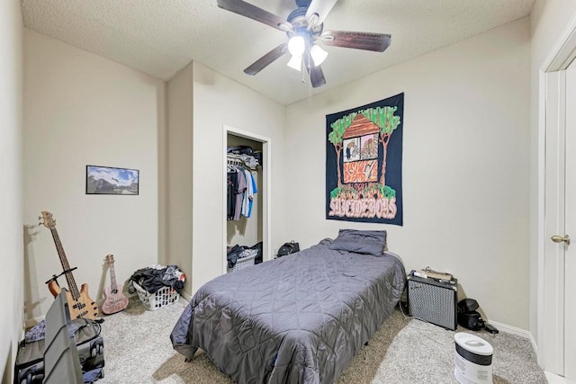 bedroom with ceiling fan, light colored carpet, a closet, and a textured ceiling