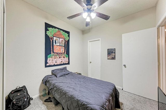 bedroom featuring ceiling fan, carpet floors, and a textured ceiling