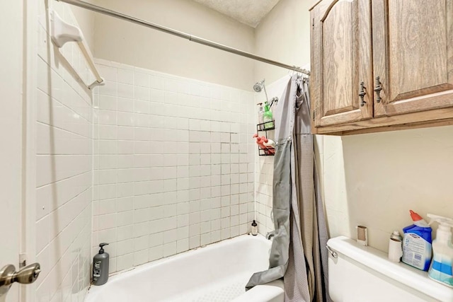 bathroom with shower / bath combo and toilet