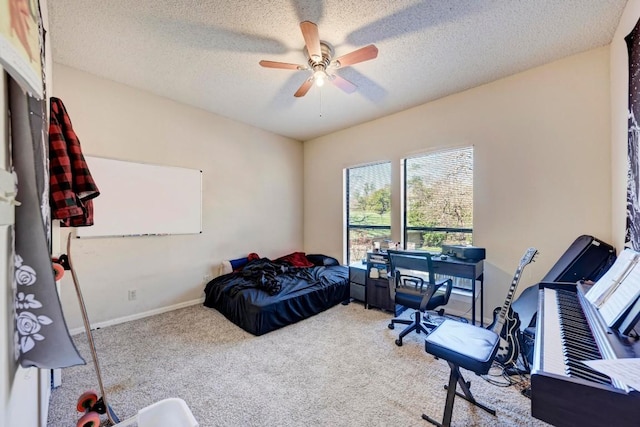 carpeted bedroom with ceiling fan and a textured ceiling