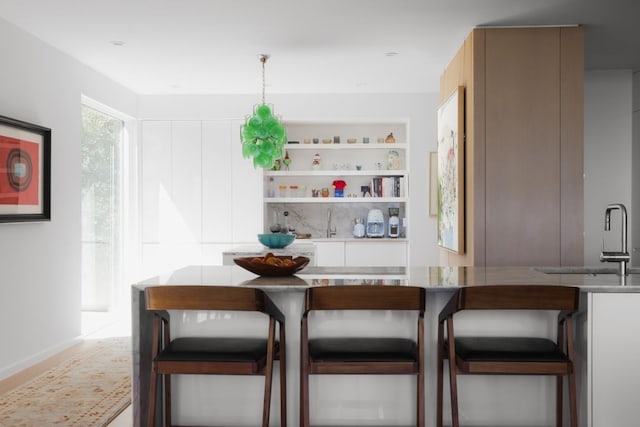 interior space featuring sink and pendant lighting