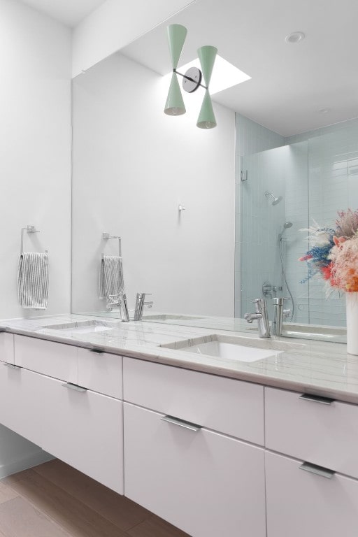 bathroom featuring vanity, an enclosed shower, and hardwood / wood-style flooring