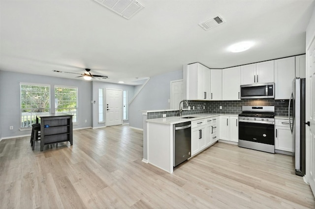 kitchen featuring white cabinetry, appliances with stainless steel finishes, and backsplash