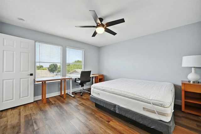 bedroom with dark wood-type flooring and ceiling fan