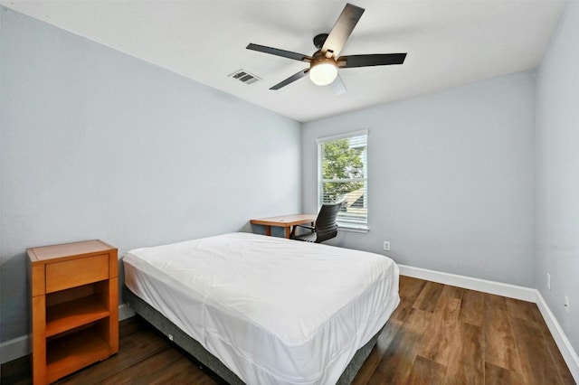 bedroom with ceiling fan and dark hardwood / wood-style flooring