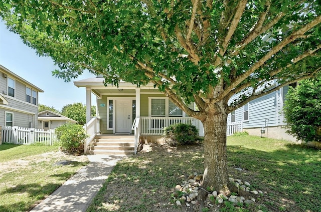 view of front of home featuring covered porch and a front lawn