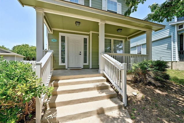 view of exterior entry featuring a porch