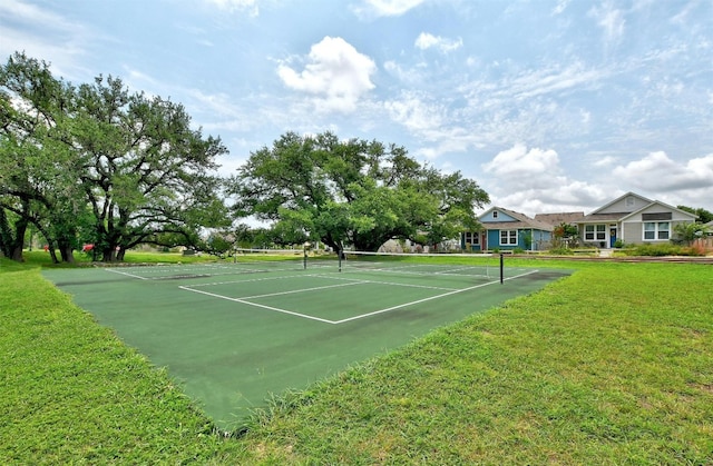 view of sport court featuring a lawn