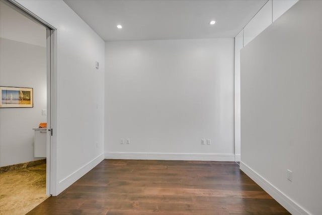 empty room with dark hardwood / wood-style floors