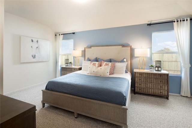 carpeted bedroom featuring vaulted ceiling