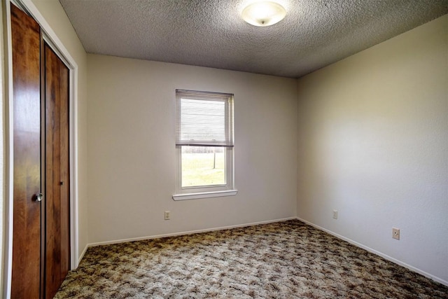 unfurnished bedroom featuring carpet flooring, a closet, and a textured ceiling