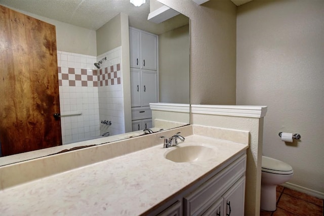 bathroom with tile patterned flooring, vanity, and toilet