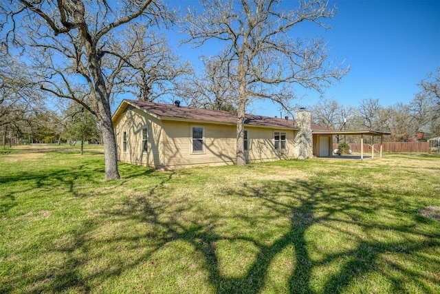 back of house featuring a lawn and a patio area