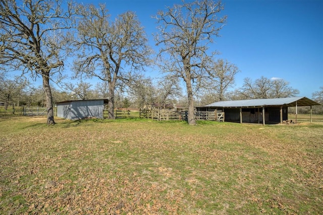 view of yard featuring an outdoor structure and a rural view