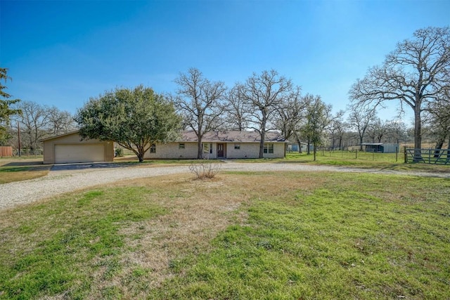 view of front of property with a garage and a front lawn